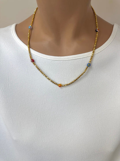 Ce bijou est composé de facettes de Bohème couleur Or plaqué 24K sur un fil élastique de grande qualité. On y retrouve aussi des perles rondes Millefiori.